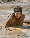 BOISE, IDAHO/USA - AUGUST 25 - Unidentified woman sits in a mud pond with a huge smile during the Dirty Dash. The Dirty dash is a