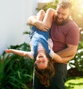 Boisterous play isnt just for boys. an adorable little girl having fun with her father in their backyard. Royalty Free Stock Photo