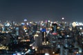 Bokeh abstract background of skyscraper buildings in Bangkok city, Thailand with lights, Blurry photo at night time. Cityscape Royalty Free Stock Photo