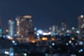 Bokeh abstract background of skyscraper buildings in Bangkok city, Thailand with lights, Blurry photo at night time. Cityscape Royalty Free Stock Photo