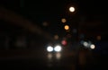 Bokeh abstract. Blurry lights of car, city in public road. Beautiful blurred light traffic system in dark night. Front view. Royalty Free Stock Photo