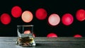 Whiskey in a glass on a bokeh background, circles red background Royalty Free Stock Photo