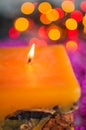 Colored candle burning against the background of new year lights bokeh Royalty Free Stock Photo