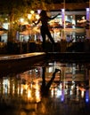 Bokeh backlight girl silhouette after rain on the street at night
