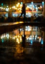 Bokeh backlight girl silhouette after rain on the street at night