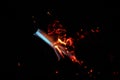 Bokeh of blue fire of a gas burner, burning coals and sparks on a black background in the dark Royalty Free Stock Photo