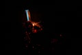 Bokeh of blue fire of a gas burner, burning coals and sparks on a black background in the dark Royalty Free Stock Photo