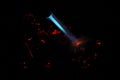 Bokeh of blue fire of a gas burner, burning coals and sparks on a black background in the dark Royalty Free Stock Photo