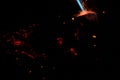 Bokeh of blue fire of a gas burner, burning coals and sparks on a black background in the dark Royalty Free Stock Photo