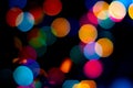 Bokeh christmas lights defocused on black background Royalty Free Stock Photo
