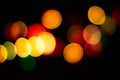 Bokeh christmas lights defocused on black background Royalty Free Stock Photo