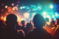 Bokeh effect with foreground focus on concertgoers sitting in the sunlight Royalty Free Stock Photo