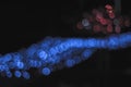 Bokeh for a festive New Year and Christmas background. Defocused abstract red and blue light circles. Royalty Free Stock Photo