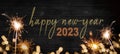 Bokeh golden flares and sparkler isolated on rustic black wooden texture - Holiday New Year`s Eve Silvester New Year 2023 Party