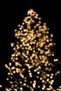Bokeh yellow lights of Christmas tree on black background