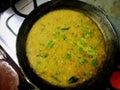 Bokeh hot of delicious yellow lentils garnished with curry leaves and coriander.