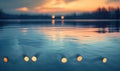 Bokeh lights reflecting off the surface of a calm lake at twilight Royalty Free Stock Photo