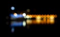 Bokeh of night scene. Blur effect from city lights in the background reflecting in the water. Defocused city lights Royalty Free Stock Photo