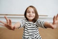 Bokeh portrait of a nine year old girl in striped black and white shirt