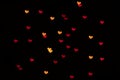 Heart-shaped bokeh lights on a black background