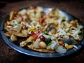 Bokeh shot of delicious street food of India, called Sevpuri or jhalmuri is served with onions, tomato and nuts topping. Royalty Free Stock Photo