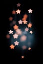 Bokeh stars background with orange and white lights, blurred effect on dark Royalty Free Stock Photo