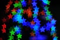 Bokeh stars colored lights on black background Royalty Free Stock Photo