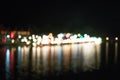 Bokeo from the light of the building at night Beautiful river town Royalty Free Stock Photo