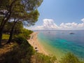 BOL,BRAC,CROATIA - AUGUST 3: Crowded beach of Zlatni Rat on August 03, 2014 in Bol, Croatia. Bol is one of the most famous