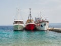 Bol, Croatia, July 25, 2021: three ships berthed side by side in the port. Ship mooring in a small port on the island of Brac.