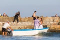 Photographer shoots a couple of affectionate newlyweds in a boat in the Black Sea bay