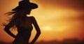 The Bold Backlight of a Sunset Casting a Cowgirl\'s Silhouette in Relief Royalty Free Stock Photo