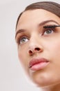 Bold beauty. Closeup studio shot of a beautiful young woman applying mascara. Royalty Free Stock Photo