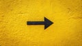 A bold black arrow points right on a textured yellow wall, indicating direction and guidance. Generative AI Royalty Free Stock Photo
