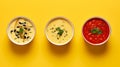 Bold And Busy: Three Bowls Of Soup On A Minimalist Yellow Background