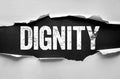 Bold distressed word DIGNITY emerges through torn paper, symbolizing respect, honor, self-worth, integrity, pride, and moral Royalty Free Stock Photo