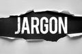 Bold distressed word JARGON revealed through torn paper, symbolizing technical language, industry-specific terms, and Royalty Free Stock Photo