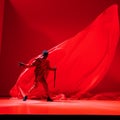 Bold Fashion Photography: A Man In Red Cloth Running On Minimalist Stage