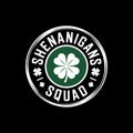 the text \'SHENANIGANS SQUAD\' encircling a green four-leaf clover. The background is solid black, Royalty Free Stock Photo