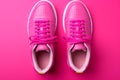 Bold pink sneakers make a statement against the pink background