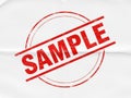 A bold red sample stamp on a plain white background with crossed lines. isolated on white background Royalty Free Stock Photo