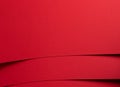 Bold scarlet red paper background with a deep matte texture and overlapping folds. Smooth geometric