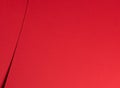 Bold scarlet red paper background with a deep matte texture and overlapping folds. Vibrant crimson