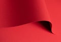 Bold scarlet red paper background with a deep matte texture and overlapping folds. Vibrant crimson