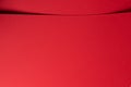 Bold scarlet red paper background with a deep matte texture and overlapping folds. Vibrant crimson
