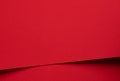 Bold scarlet red paper background with a deep matte texture and overlapping folds. Vibrant crimson