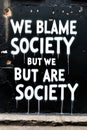 Urban Graffiti: Blame society on black wall Royalty Free Stock Photo