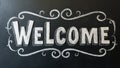 Bold Welcome in block letters on chalkboard with decorative flourishes Royalty Free Stock Photo