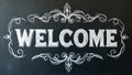 Bold Welcome in block letters on chalkboard with decorative flourishes Royalty Free Stock Photo