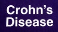 Bold white text awareness message for Crohns Disease printed clearly on deep purple fabric Royalty Free Stock Photo
